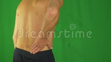 男人用手掌<strong>摩擦</strong>他的下背部，因为背部疼痛。